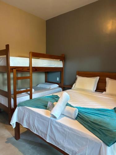two beds in a room with two bunk beds at Casa Concha-Maceio in Camocim