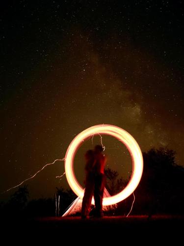 a person is holding a circle in the sky at Romantic Wildlife Tipi Teepee Tomnatic Bihor Romania Apuseni in Tomnatic