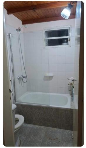 a bathroom with a bath tub and a toilet at Patagonia Faro Norte Lighthouse in Carmen de Patagones