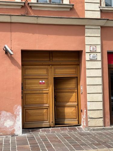 two wooden garage doors in the side of a building at DH Duomo II apartment in Košice