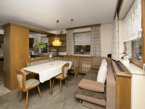a kitchen and dining room with a table and chairs at Apartment in Hinterbichl near Ski Bus in Reutte