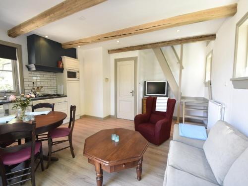 a living room with a couch and a table at Apartment Sint Maartensbrug near Beach in Sint Maartensbrug