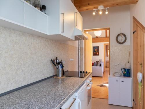 a kitchen with white cabinets and a counter top at Apartment in St Stefan near Nassfeld Ski Area in Tratten