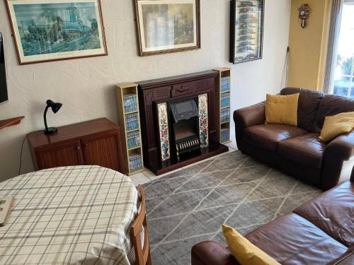 a living room with a couch and a fireplace at Rain Hill Cottage - Sleeps 4 Parking & Pets Ok in Louth