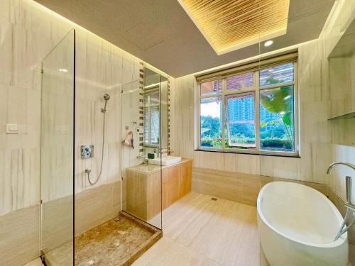 a bathroom with a tub and a shower and a sink at Lakeview Park Villas - Every Duplex with Private Pool in Ho Chi Minh City