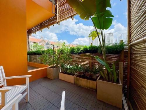 a balcony with a white bench and plants on it at Lakeview Park Villas - Every Duplex with Private Pool in Ho Chi Minh City