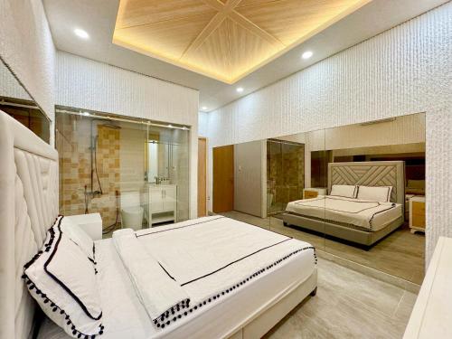 a large bedroom with two beds and a shower at Lakeview Park Villas - Every Duplex with Private Pool in Ho Chi Minh City