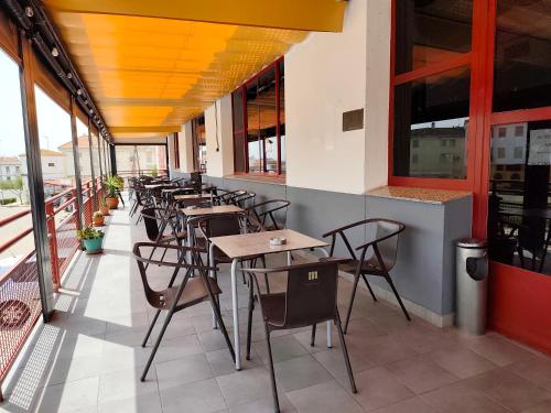a row of tables and chairs in a restaurant at Hotel Peña Cruz in Malpartida de Cáceres