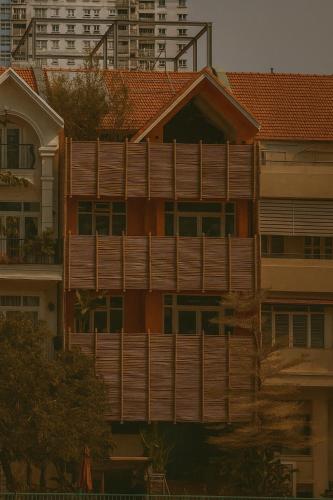 an apartment building with a wooden privacy fence at Lakeview Park Villas - Every Duplex with Private Pool in Ho Chi Minh City