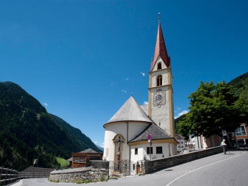 a church with a clock tower on a street at Apartment in Kappl near Ski Slopes in Kappl