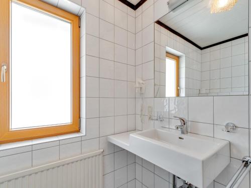 a white bathroom with a sink and a window at Apartment in Kappl near Ski Slopes in Kappl