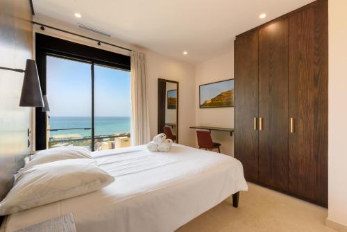 a bedroom with a large white bed and a large window at MSW37 - Luxury Penthouse with Private Pool and Spa in Torrox Costa