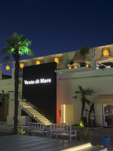 a sign on the side of a building with palm trees at Mandarinnart HOTEL in Astara