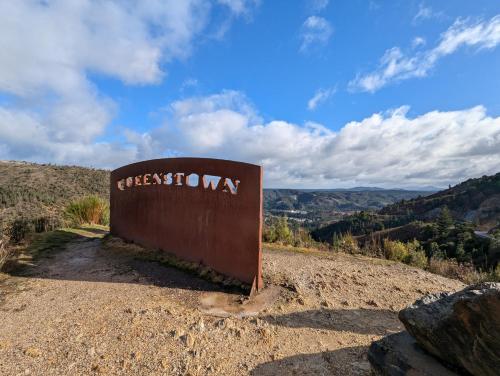 a sign for the cheetah sign on top of a hill at Quentin's Cottage in Queenstown
