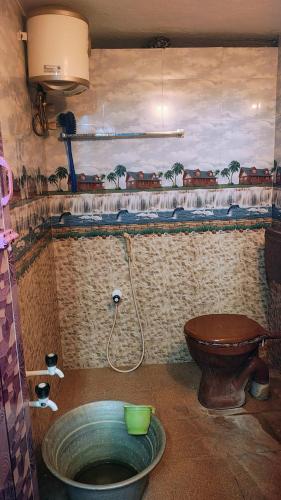 a bathroom with a toilet and a sink at RHS rooms in Tiruvannāmalai