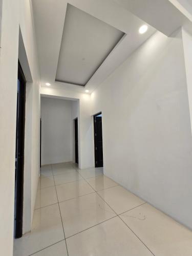 an empty room with white walls and a ceiling at Hello rooms 29 in Haripād