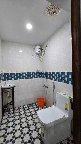 a bathroom with a toilet and a sink at Hello rooms 29 in Haripād