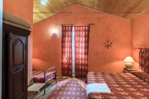 a bedroom with two beds in a room with orange walls at Agriturismo Borgo Spagnoli in Magione