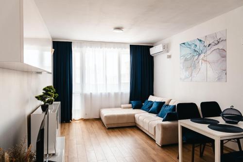 a living room with a couch and a table at Renovated 1 Bedroom - Full Kitchen - Parking - 4km Tsarevets in Veliko Tŭrnovo