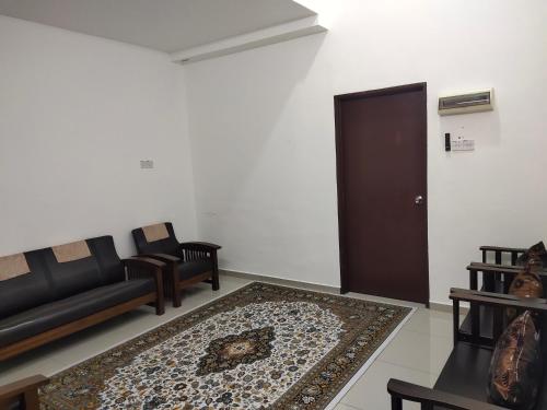 a living room with a couch and a rug at Homestay Alor Setar - VILLA FARAH in Alor Setar