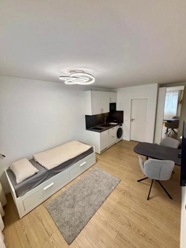 a small bedroom with a bed and a kitchen at 1 Room Studio in Hanover in Hannover