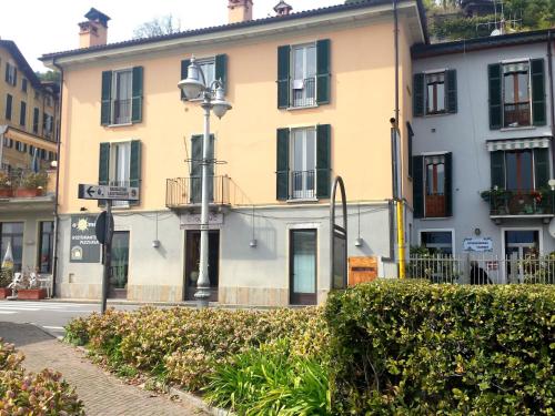 a yellow building with black windows on a street at Apartment in Ghiffa with Lake Maggiore Views in Ghiffa