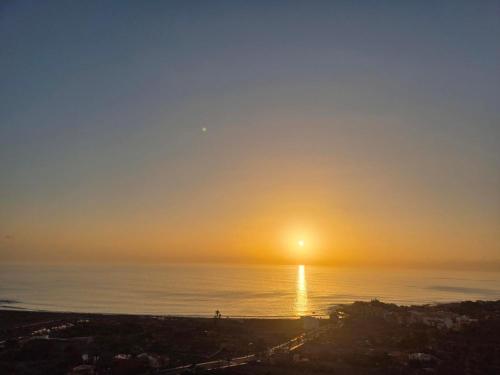 a sunset over the ocean with the sun in the sky at Casa Cira in Calera
