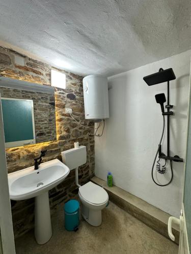 a bathroom with a white toilet and a sink at Mark Toma Guesthouse 