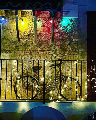 a bike parked next to a wall with lights at Suites with pool in Can Fressa Garden - Only Adults in Alaró