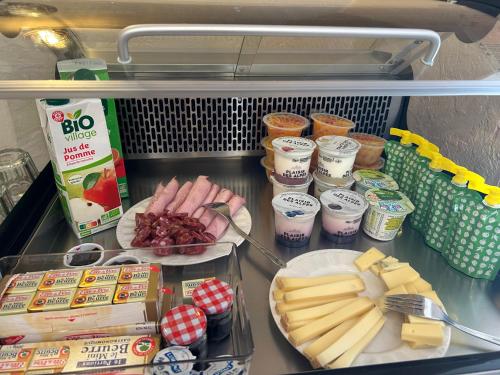 a refrigerator with a bunch of food on a counter at Gite Clé des Champs in Montenois