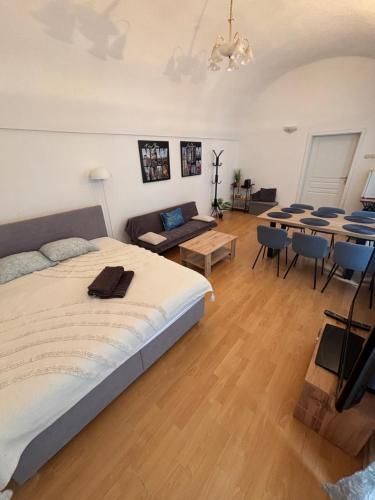 a bedroom with a large bed and a dining room at DH Duomo V BIG Party apartment 12 people in Košice