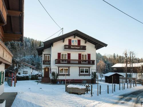 a building with red and white in the snow at Chalet in Ellmau near Skiwelt Slopes in Ellmau