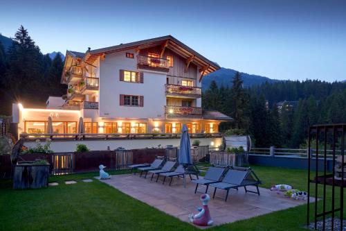 a large building with chairs and a patio at Der Waldhof - Unique - A hidden gem in Sankt Anton am Arlberg