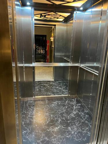 a metal elevator with a marble floor in a room at Pusula Ordu in Ordu