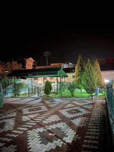 a pavilion with a bench in a parking lot at night at Pusula Ordu in Ordu