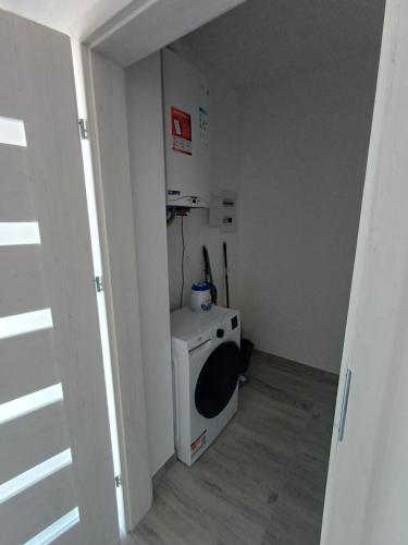 a small room with a small washing machine in it at Apartamenty Jasna, Mieszkania in Ostrów Wielkopolski