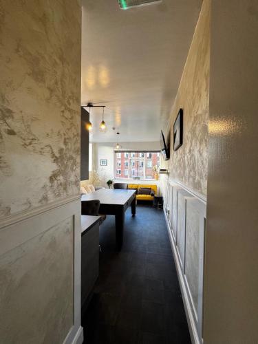 a hallway with a table and a dining room at Central Sheffield 3-Bed Apt Sleeps 6 with Parking in Sheffield