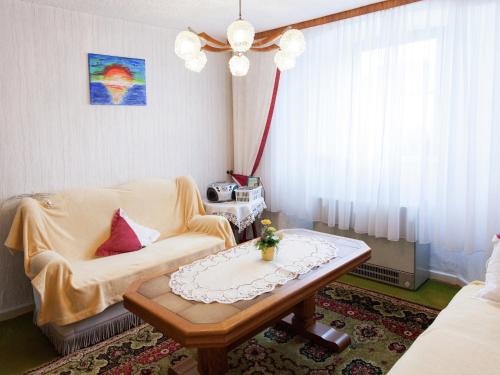 a living room with a couch and a coffee table at Hontheim Farmhouse Retreat in Sellerich