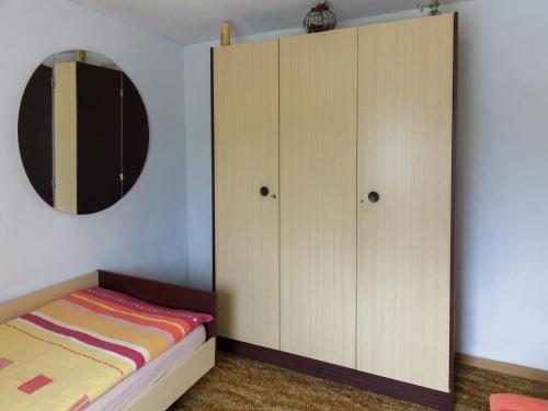 a bedroom with a bed and a large cabinet at Hontheim Farmhouse Retreat in Sellerich