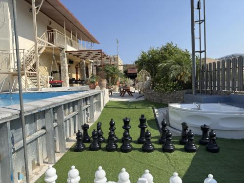 a chess board on a lawn next to a pool at Villa Olive Tree with Private Pool in Kissamos
