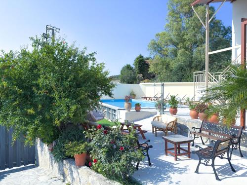 a patio with chairs and tables and a pool at Villa Olive Tree with Private Pool in Kissamos