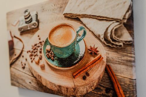 a cup of coffee sitting on a wooden table at Tiki's Bar studio in Bucharest