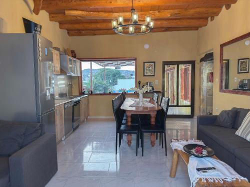 a living room with a table and a kitchen at Villa Olive Tree with Private Pool in Kissamos