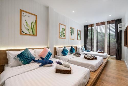 a room with two beds with a blue elephant on them at Sense Pool Villa HuaHin - 4BR&BBQ, 5 Min Walk to the Beach in Hua Hin
