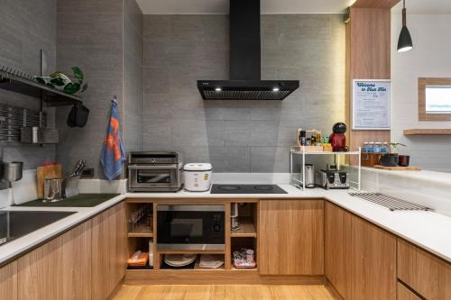 a kitchen with a sink and a stove top oven at Sense Pool Villa HuaHin - 4BR&BBQ, 5 Min Walk to the Beach in Hua Hin