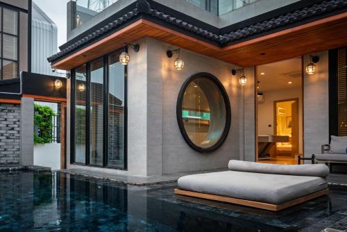 a bedroom with a mirror on the side of a house at Sense Pool Villa HuaHin - 4BR&BBQ, 5 Min Walk to the Beach in Hua Hin