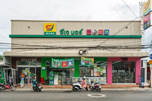 a store with three scooters parked in front of it at Sense Pool Villa HuaHin - 4BR&BBQ, 5 Min Walk to the Beach in Hua Hin