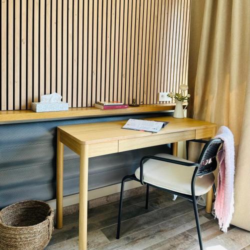a wooden desk with a chair in a room at OrigiNell - EmotioNell in Ouffet