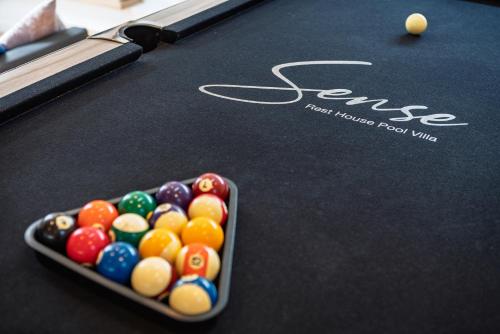 a bowl of billiard balls on a pool table at Sense Pool Villa HuaHin - 4BR&BBQ, 5 Min Walk to the Beach in Hua Hin