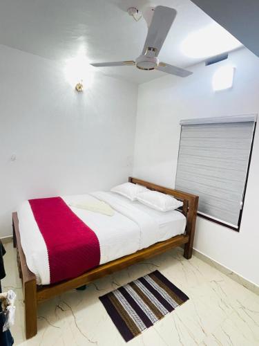 a bed in a room with a ceiling fan at The soul view homestay in Suryanelli
